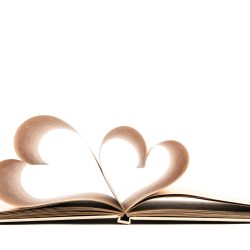 Book with opened pages of shape of heart isolated on white background